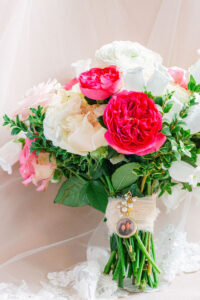 bridal flatlay memorial photo locket on bouquet